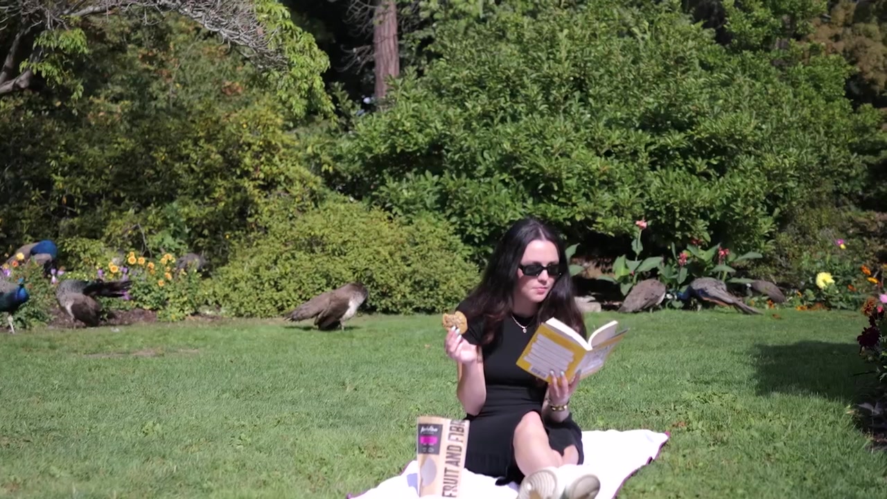 Hannah reading in a Victoria park